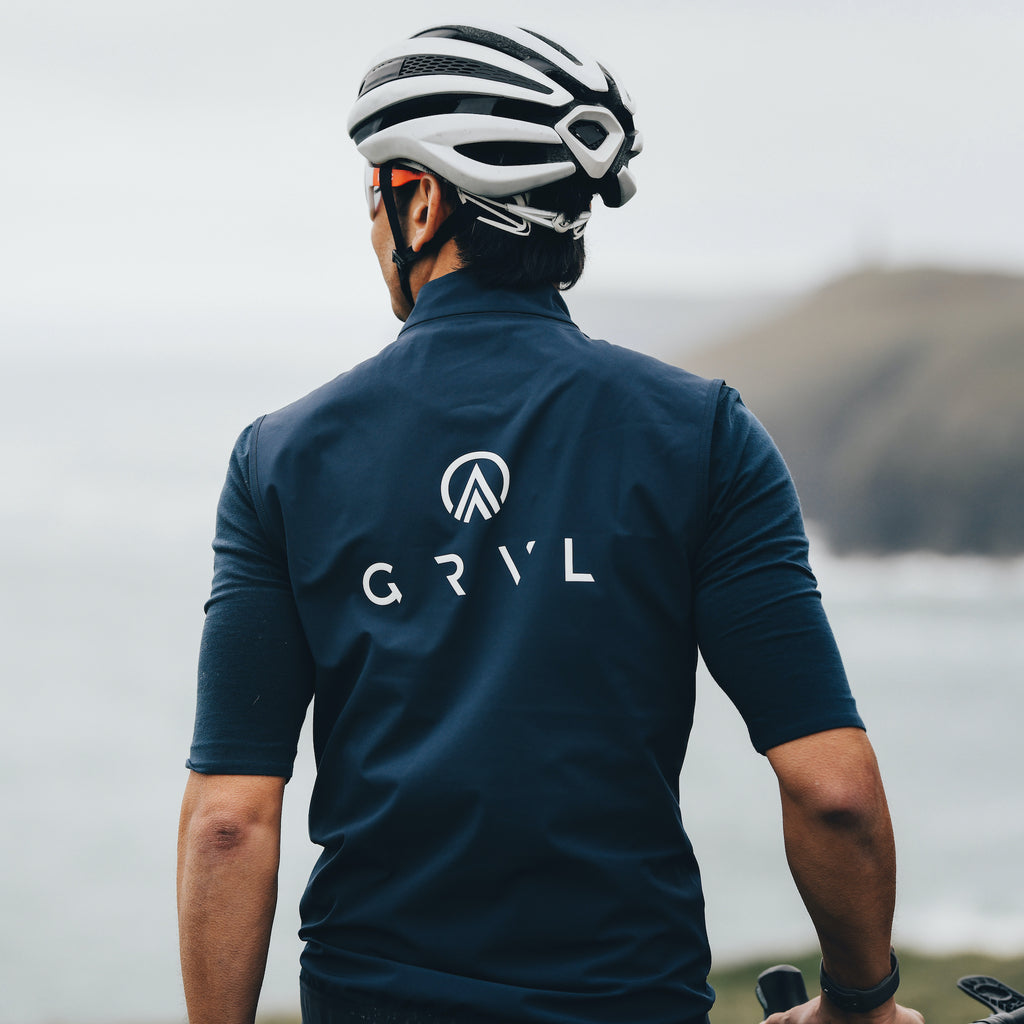 Sustainable cycling clothes by GRVL including the navy gilet and polo shirt made from eco fabrics